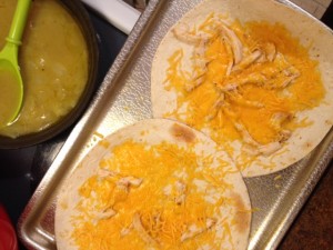In the oven (on a baking sheet) or in microwave, melt cheese all over the top of each tortilla so that it covers most of the surface area.