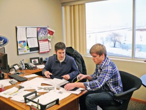 Co-Line employee Peter Smith gives intern Jeremy Van Beek a hands-on experience with estimating and quoting.