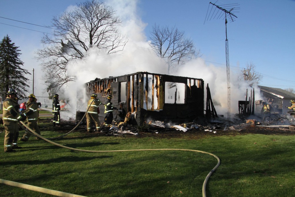 Members of Sully’s Fire Department assist three other departments on the scene of the Bryce and Carla Van Gorp house fire in Reasnor, which was a total loss. The charred shell of the house is all that stood once the flames were extinguished.