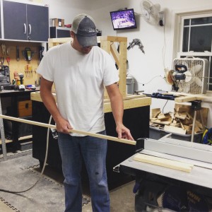 Ryan McFarland runs material through his table saw for a customer’s project.