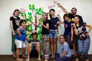 Katy Sevcik (fourth from left) and her team based out of Singapore have fun posing with the Fruits of the Spirit.
