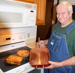 Carlos Heatherly is pictured with his favorite kitchen item – a copper-coated titanium pan. He says everyone should own the versatile non-stick pan which, in this case, he used to bake bread. On the stovetop behind him are a pie and a version of Fly-a-way Chicken Casserole made with hamburger instead of chicken. Heatherly’s wife loved their stove with a convection oven, and he wishes she would have taught him how to use it before she passed away. “I’ve had to learn the hard way,” he said.