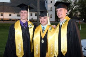 Seniors Brandon Dunsbergen, Daniel Zimmerman, and Bailee Samson pose for a picture in the congratulatory line following the ceremony. Graduates shared hugs, tears, and memories with family and friends who wished them well following their high school graduation. 