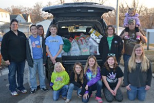 Shown with the load of food for the food pantry from left are: Front, Jaelynn Smith, Lindy Bokhoven, Dakotah Bokhoven, Esther Collins, Ellie Dunsbergen; back, Cassie Bokhoven, Gage Elscott, Erin Elscott, Mason Jansen, Lynn Dunsbergen, and Shannon Dunsbergen holding Emma Elscott.