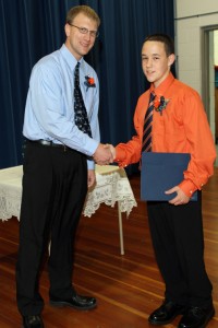Ben Vander Molen accepts his SCS diploma from Mark De Vries, board president.