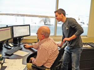 Connor Dunsbergen, a junior from Sully, looks on as Co-Line employee Doug Richards explains the quoting process.