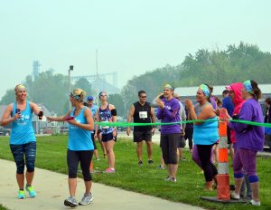 Team members show support as Jill Van Dyke passes off the timing bracelet to Tashia Ehresman before the storm hit. Van Dyke – one who didn't train much prior to the race – was the calmest of the whole group and always had a smile on her face while running.