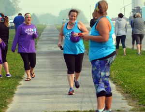 Christine Morningstar finishes her leg of the race while Alison Agan gets ready to take off with Kristi Brummel cheering in the background.