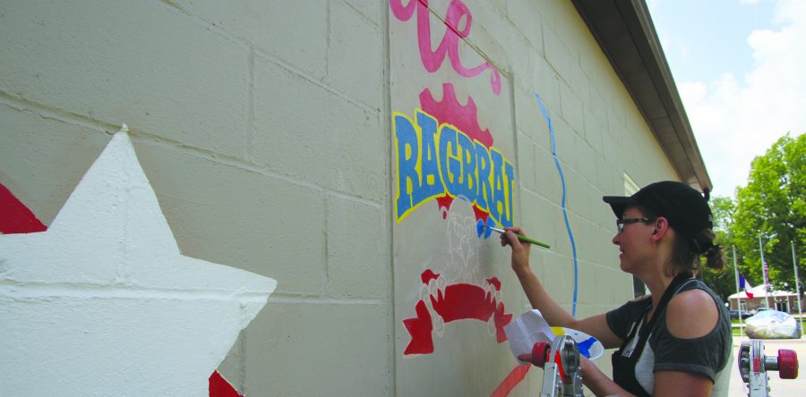Sully artist Svetlana Van Wyk paints wall mural for bike riders to autograph