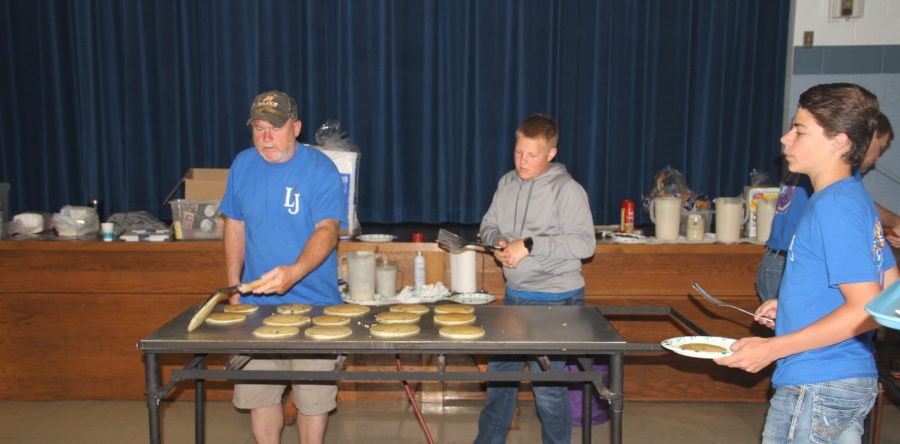 Large crowd at rainy pancake breakfast on Memorial Day